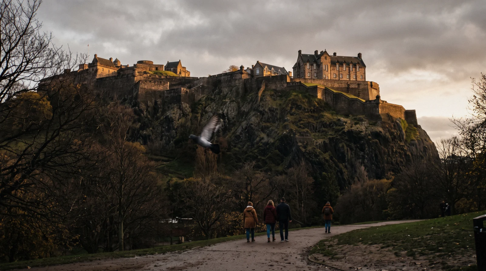 The batteries of Edinburgh Castle catching low October light above the crag, seen from Princes Street Gardens, Edinburgh Castle Scotland