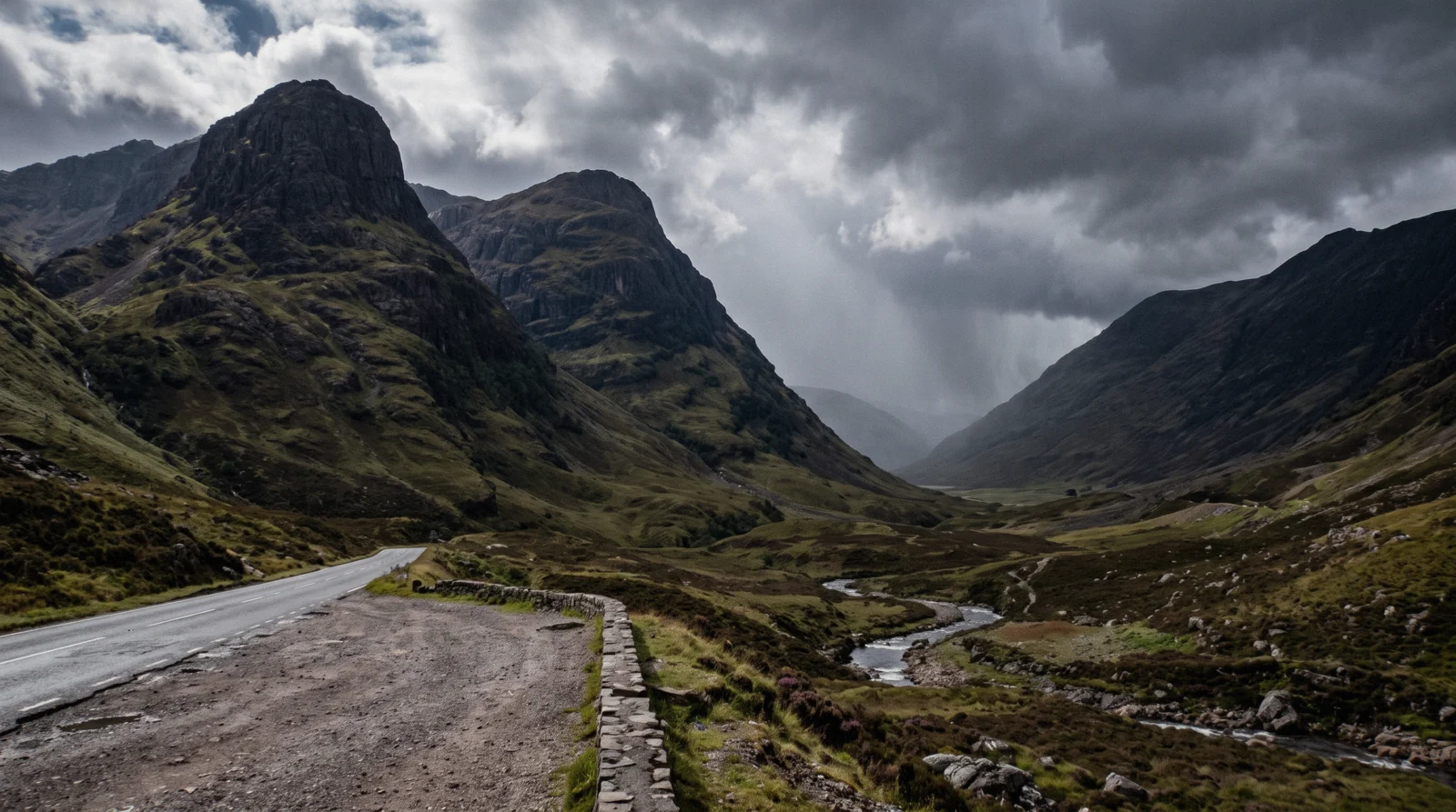 The Three Sisters ridges rising above the A82 through Glen Coe on a day trip from Edinburgh, cloud shadow moving across the glen