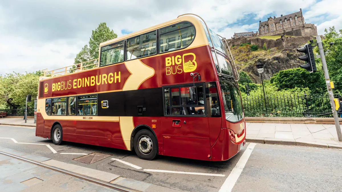Big Bus open-top double-decker on Waterloo Place during a hop-on hop-off bus tour of Edinburgh