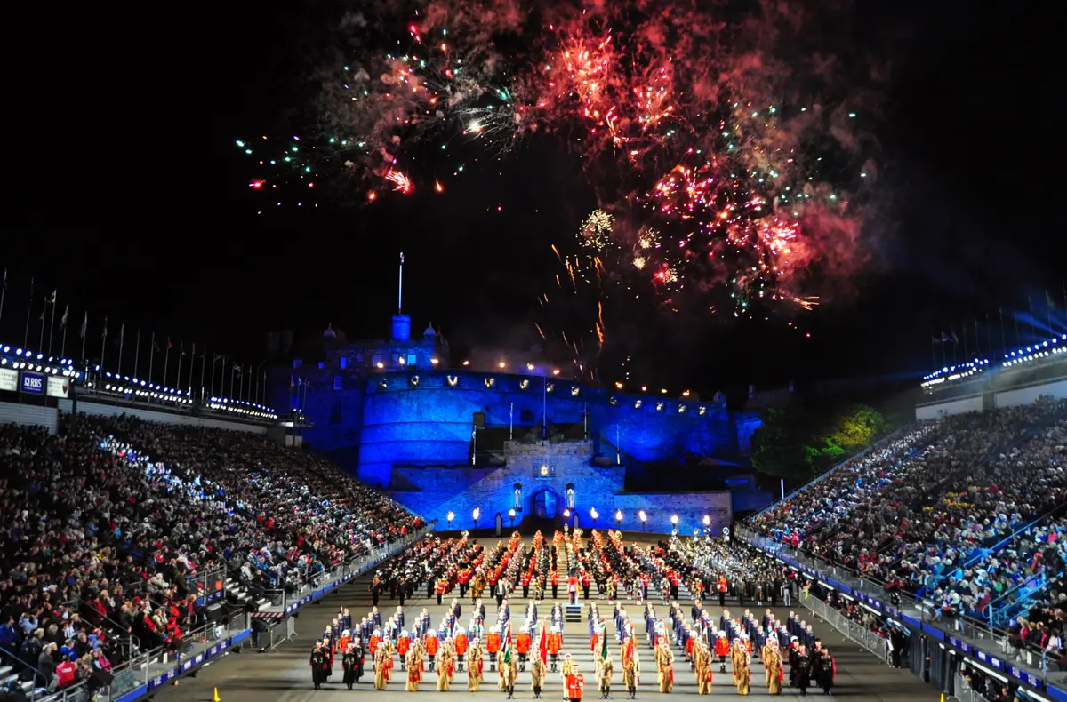 Massed pipes and drums on the floodlit castle esplanade during the Royal Edinburgh Military Tattoo